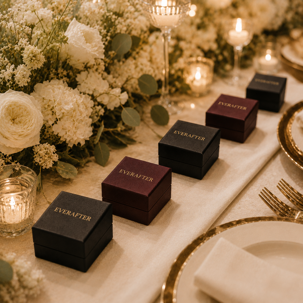 Custom jewelry boxes arranged as place-setting favors at a luxury wedding event